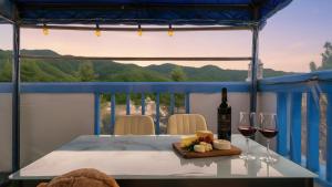 a table with two glasses of wine and cheese at Chuncheon Dogandstay in Chuncheon