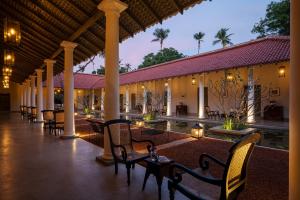 a resort with tables and chairs and a pool at Rekawa Wellness Resort in Tangalle