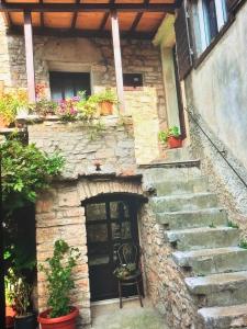 a stone house with stairs and a door with flowers at Molo selo area in Stari Grad