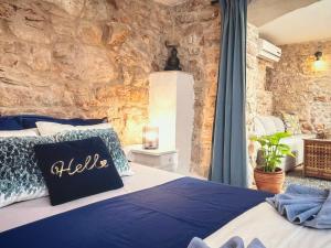 a bed in a room with a stone wall at Molo selo area in Stari Grad