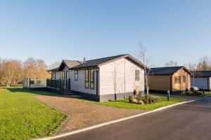 a small house on the side of a road at Finest Retreats - Pembroke Luxury Lodge in Bourn