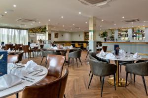 a restaurant with tables and chairs and a bar at Finest Retreats - Pembroke Luxury Lodge in Bourn