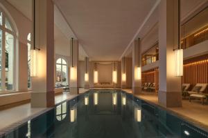 an indoor swimming pool in a building with a house at The Florentin by Althoff Collection in Frankfurt