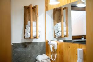 a bathroom with a pile of towels on the wall at Glamping Podgoro with private hot tube - Rogatec in Rogatec +43 photos
