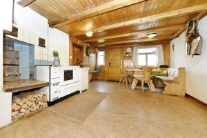 a large kitchen with a stove and a dining room at Ferienhof Steurer in Balderschwang