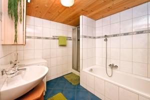a bathroom with a sink and a bath tub at Ferienhof Steurer in Balderschwang +27 photos