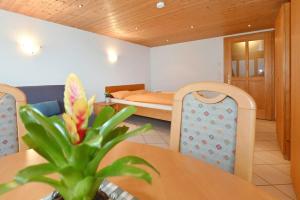 a room with a dining table and a bedroom at Ferienhof Steurer in Balderschwang