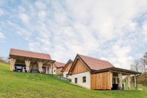 a house on top of a grassy hill at Glamping Podgoro with private hot tube - Rogatec in Rogatec
