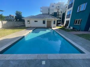 a swimming pool in the backyard of a apartment building at Modern Kingston Apartment Suite With Pool & Ocean View in Kingston