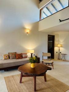 a living room with a couch and a table at Shambhala in Bhopal