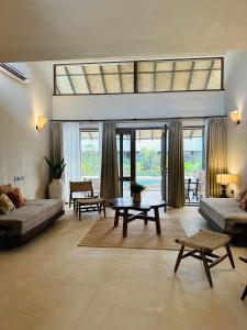 a large living room with couches and a table at Shambhala in Bhopal