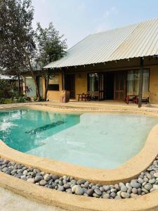 a swimming pool in front of a house at Shambhala in Bhopal