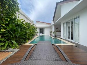 a swimming pool in the backyard of a house at Ariani Villa in Jimbaran