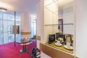 a room with a table and coffee makers on a shelf at Soho Boutique Granada in Granada