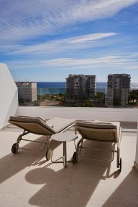 a balcony with two tables and a view of the ocean at Lucentina Line - Be Line Group in Villajoyosa