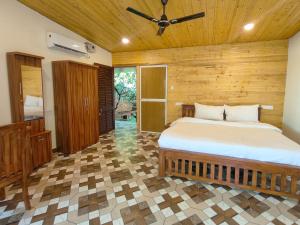 a bedroom with a bed and a ceiling fan at The Racha Agonda in Agonda