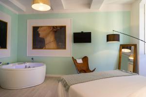 Un dormitorio con bañera, cama y televisión. en Apartment Perugia, en Perugia