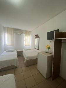 a hotel room with two beds and a mirror at denge pansiyon in Datca