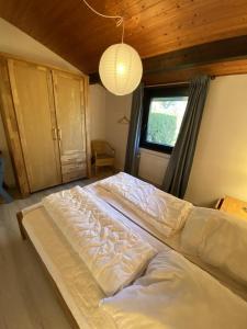 a large white bed in a room with a window at Haus H7 in Großwürden