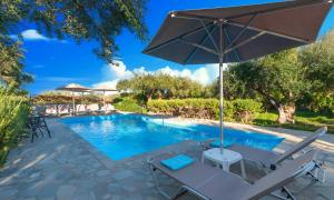 a pool with a chair and an umbrella at Plaisir Beachside Apts in Agios Nikolaos