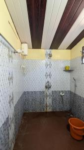 a bathroom with a shower and a toilet at Coco Beach Front Stay & Cafe in Gokarna