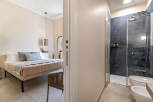 a bedroom with a bed and a shower and a sink at Le Valli in Pellestrina +35 photos
