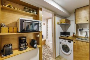 a kitchen with a washing machine and a microwave at Maison Melle in Skopelos Town +29 photos