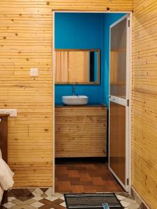 a bathroom with a sink and a blue wall at The Racha Agonda in Agonda