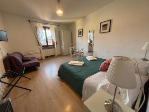 a bedroom with a bed and a table with a lamp at At Home Bed and Breakfast in Lucca