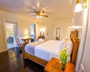 a bedroom with a bed and a ceiling fan at Turks Head Inne in Grand Turk