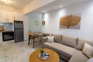 a living room with a couch and a table at Amelia Summer Homes in Pérdika