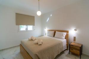 a bedroom with a bed with two towels on it at Amelia Summer Homes in Pérdika