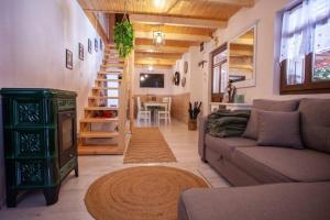 a living room with a couch and a table at Nagyon Vadon vendégház in Háromhuta