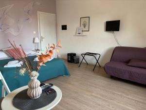 a living room with a vase of flowers on a table at At Home Bed and Breakfast in Lucca +37 photos