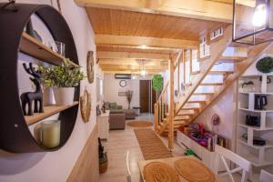 a room with a staircase and a living room at Nagyon Vadon vendégház in Háromhuta