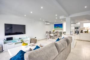 a living room with a couch and a table at Fishermans Lodge in La Cala de Mijas
