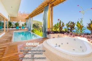 a bathroom with a tub and a swimming pool at Seaview Faralya in Faralya