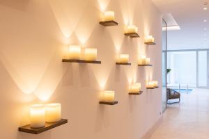 a wall with lights on a wall in a room at Hiddenbay Teos Hotel in Seferihisar
