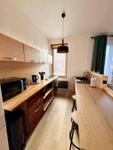 a kitchen with a wooden counter top and a table at Bright loft-style duplex 6 people Dunkirk in Coudekerque-Branche