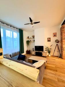 a living room with a couch and a ceiling fan at Bright loft-style duplex 6 people Dunkirk in Coudekerque-Branche +14 photos