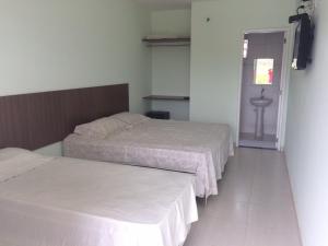 Cama ou camas em um quarto em Pousada Primavera