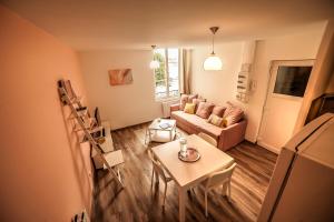 a living room with a couch and a table at Le Millésime in Chalons en Champagne