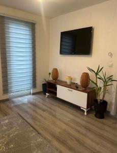 a living room with a flat screen tv on a wall at Stan Krndija - Tesanj in Tešanj