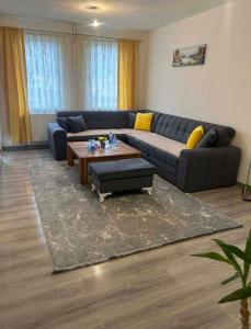 a living room with a couch and a coffee table at Stan Krndija - Tesanj in Tešanj
