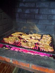 a grill with a bunch of food on it at Cabana Geta&Mircea in Beclean