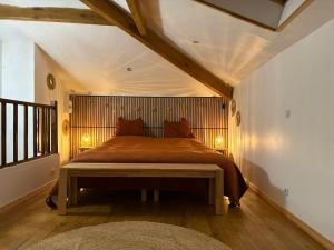 a bedroom with a large bed with a wooden headboard at Le Jardin d'Elusa in Eauze +28 photos