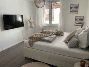 a bed with a blanket on it in a room at Little Royal in Garbsen