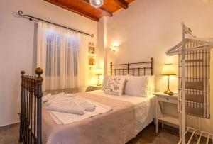 a bedroom with a bed with a metal bed frame at Heliotropio Studios & Apartments in Pollonia +274 photos