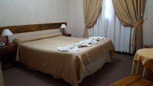Una cama o camas en una habitación de Kalenshen Calafate