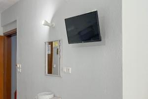 a flat screen tv hanging on a wall at Villa Leonidas in Nea Vrasna
